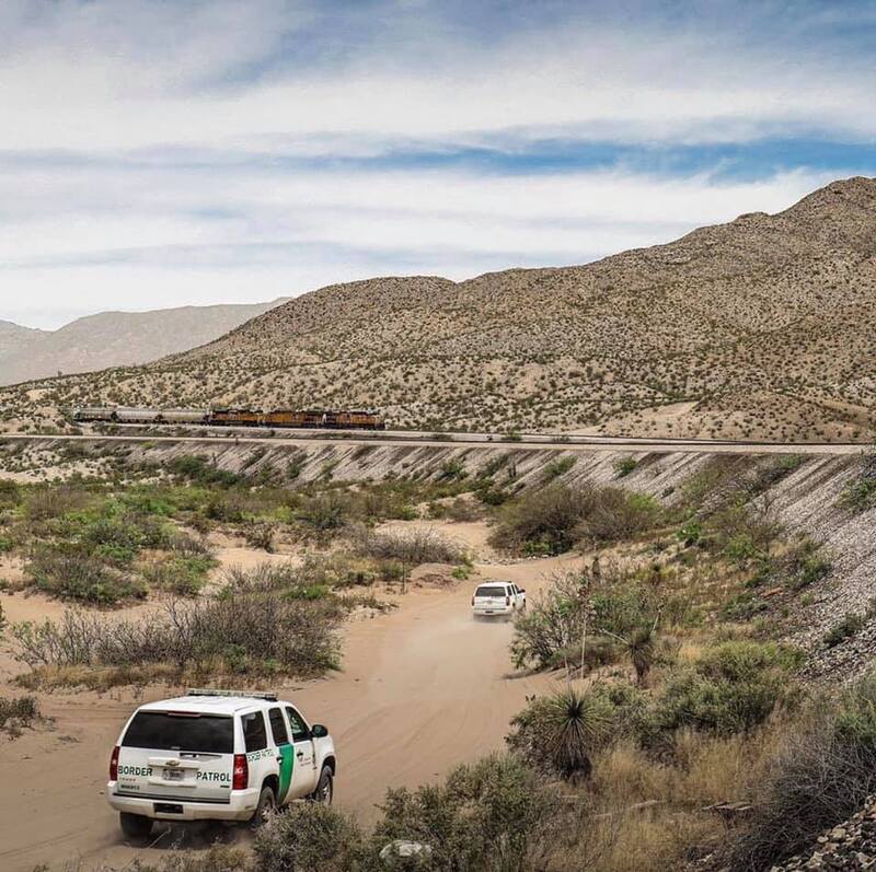 Border Patrol USBP miscellaneous modern vehicle in the desert road near a train
