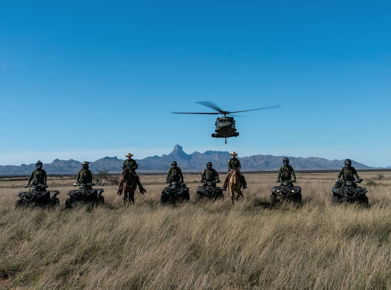 Border Patrol USBP miscellaneous modern agents and ATVs near flying helicopter 