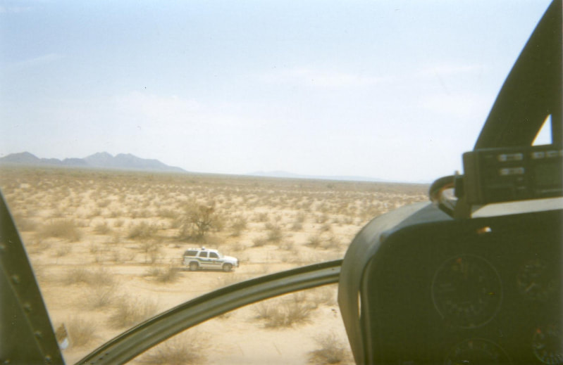 Border Patrol USBP miscellaneous modern helicopter flying over vehicle