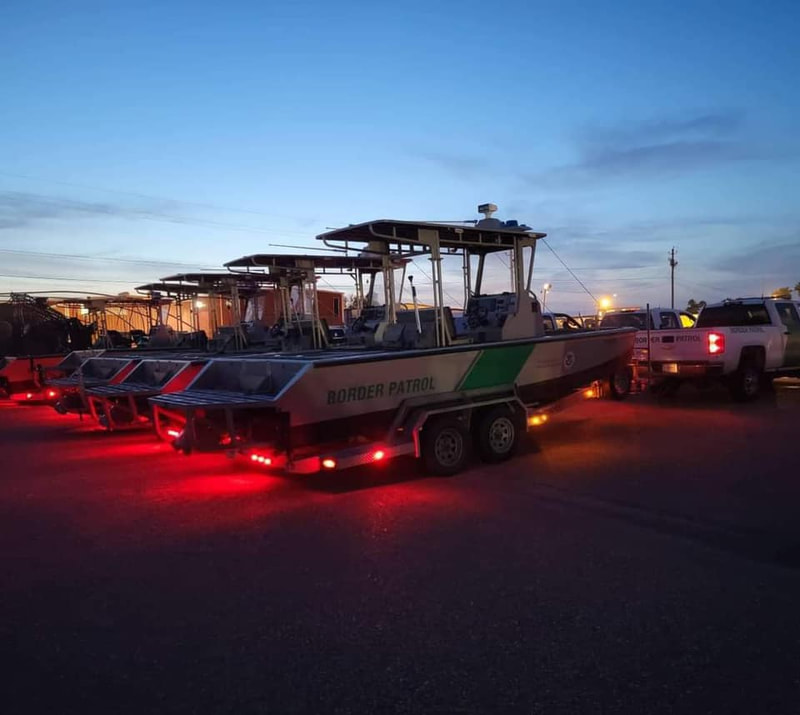 Border Patrol USBP miscellaneous modern boats on trailers red lights sunset