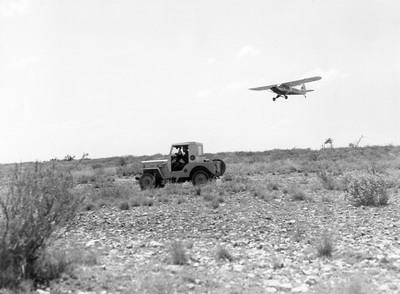 Border Patrol USBP Miscellaneous Historical history old airplane flying low over a jeep in the desert