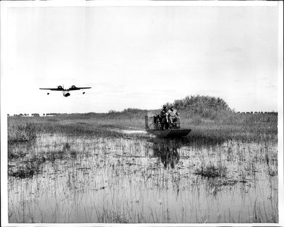 Miscellaneous Historical history old airboat with a sea plane flying low