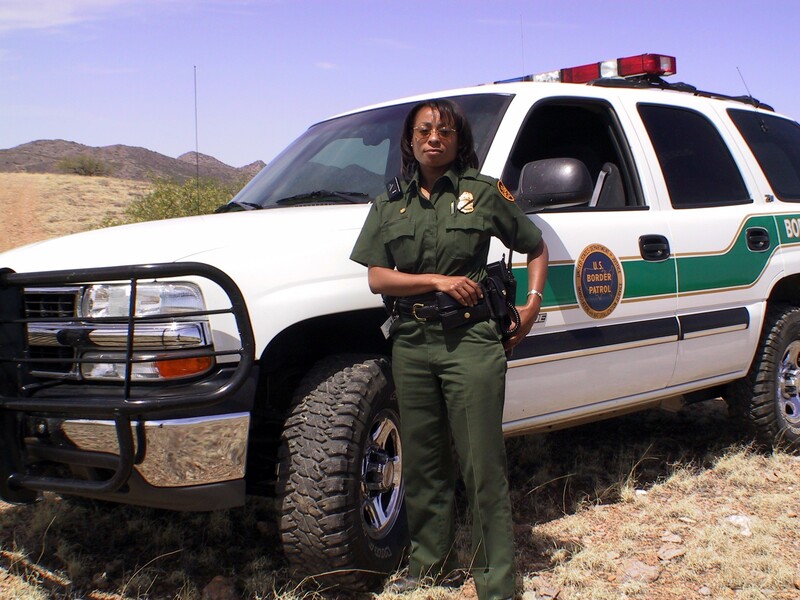 Border Patrol USBP miscellaneous modern female agent in front of vehicle in the desert