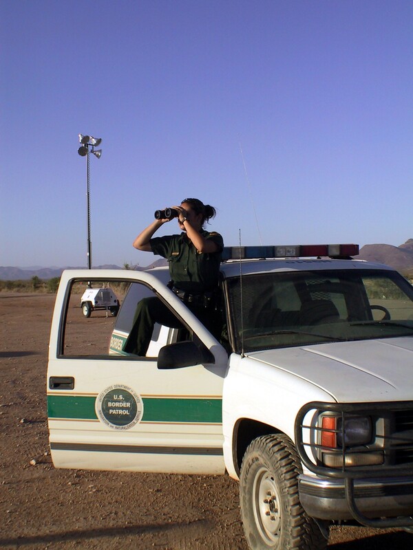 Border Patrol USBP miscellaneous modern agent poses in vehicle using binoculars 