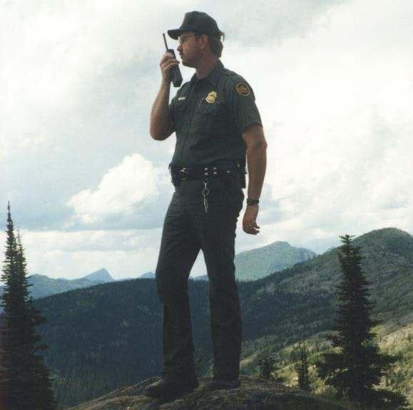 Border Patrol USBP miscellaneous modern agent uses his radio in the field
