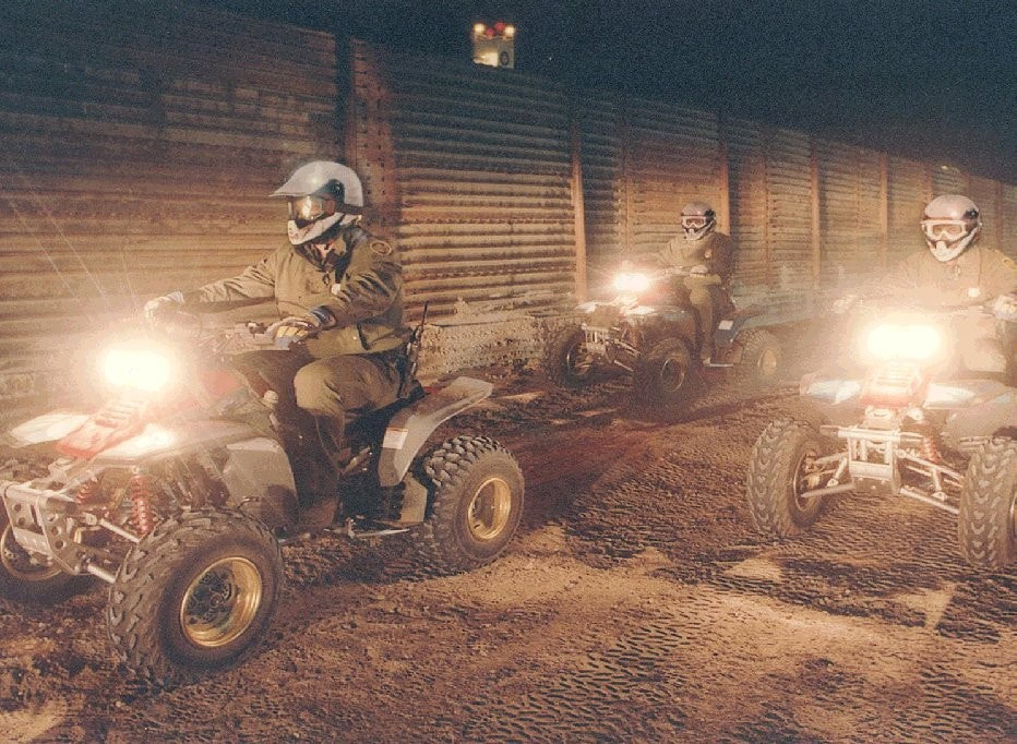 Border Patrol USBP miscellaneous modern ATV agent riding at night near the fence