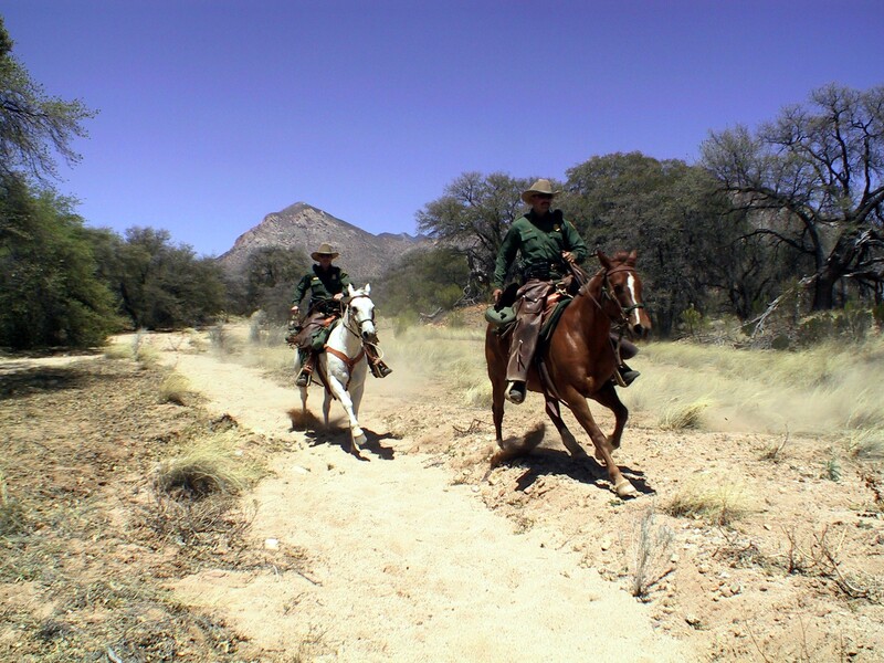 Border Patrol USBP miscellaneous modern two horse patrol agents riding on a dusty trail