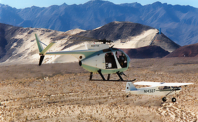 Border Patrol USBP miscellaneous modern helicopter flying with a fixed-wing plane