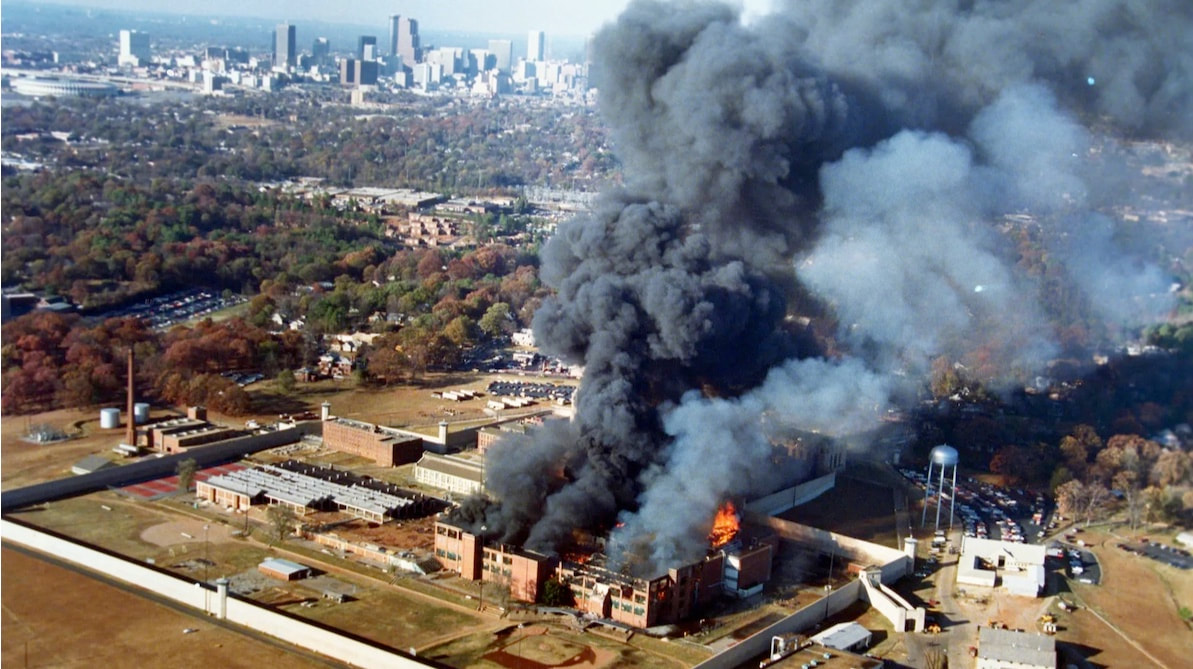 The Atlanta Federal Penitentiary aflame during the 1987 riots.  Photo: Calvin Cruce/Courtesy of the Atlanta Journal-Constitution and Georgia State University Library