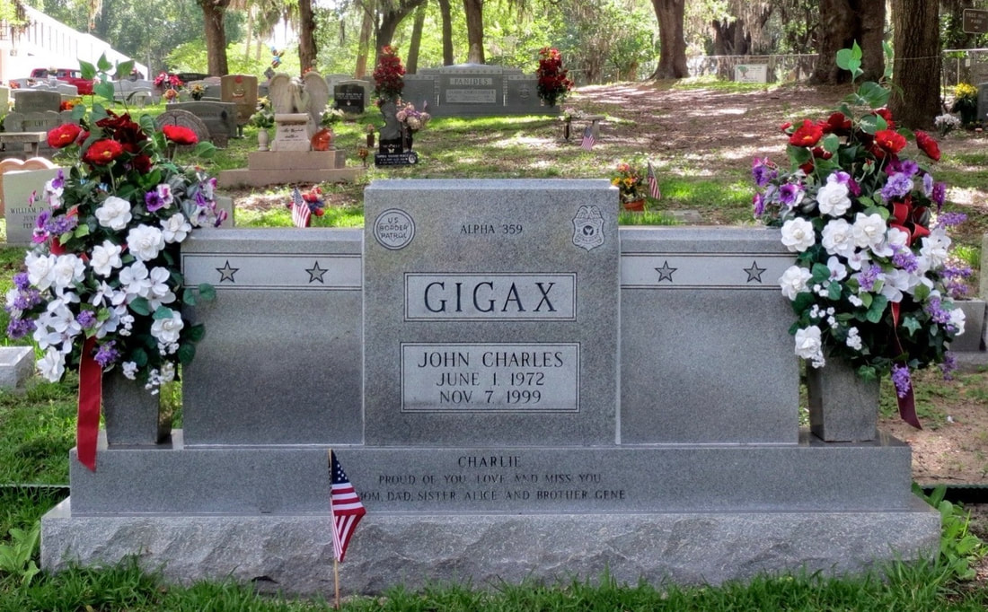 Fallen Border Patrol Agent John Charles Gigax's tombstone. Fallen Border Patrol Agent Jason C. Panides' tombstone in is the background.