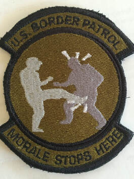 A patch showing one person kicking the other in the crotch with the caption 