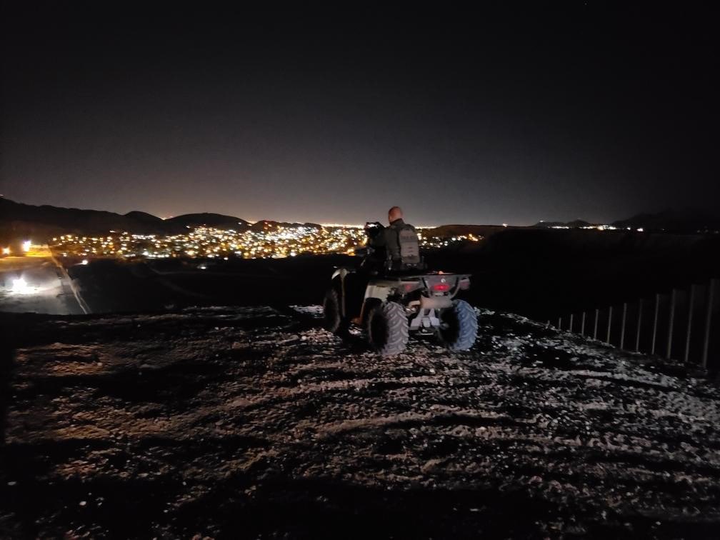 Border Patrol USBP miscellaneous modern agenting in the mountains on an ATV looking at the city lights