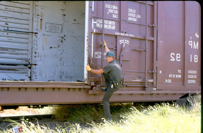 USBP Border Patrol photographs 1970-1990 an agent climbing into a train