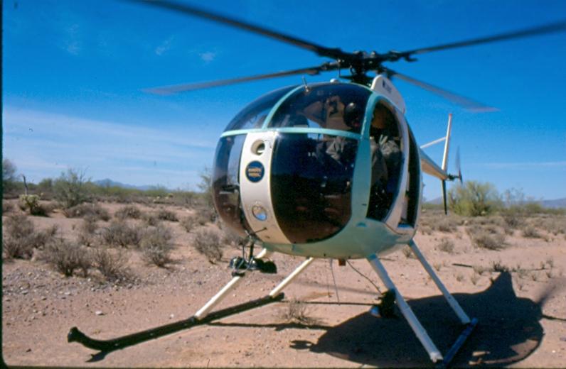 USBP Border Patrol photographs 1970-1990 a helicopter on the ground in the desert