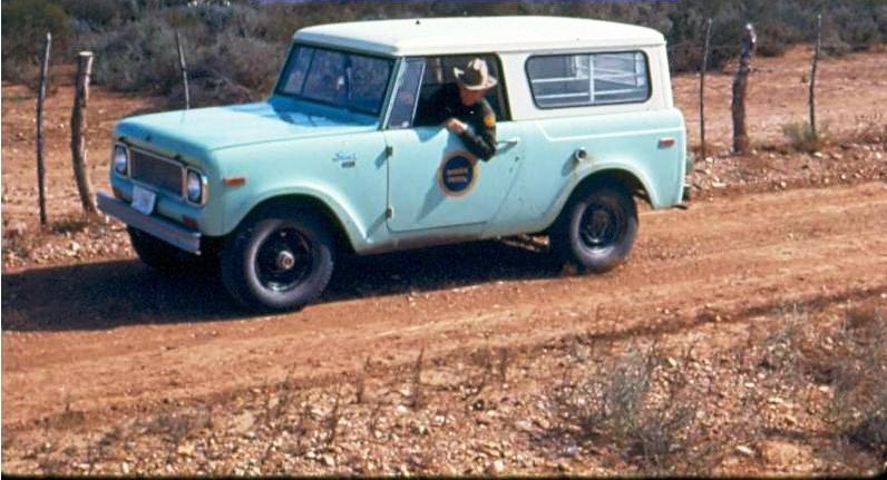 USBP Border Patrol photographs 1970-1990 agent sign cutting from the window of a sea foam green jeep