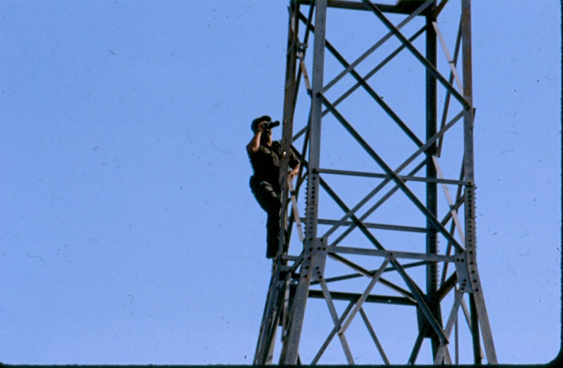 USBP Border Patrol photographs 1970-1990 agent on a tower using binoculars