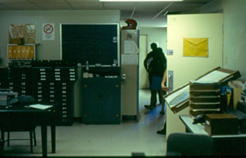USBP Border Patrol photographs 1970-1990 to agents talking in a station