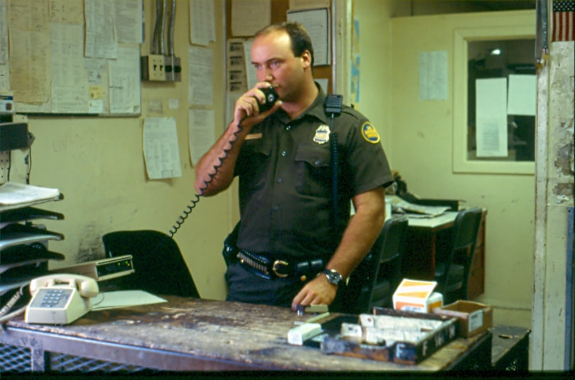 USBP Border Patrol photographs 1970-1990 an agent speaking on a radio inside a station