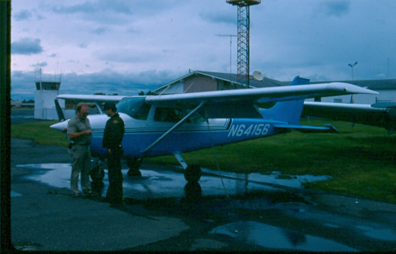USBP Border Patrol photographs 1970-1990 two people standing next to an airplane