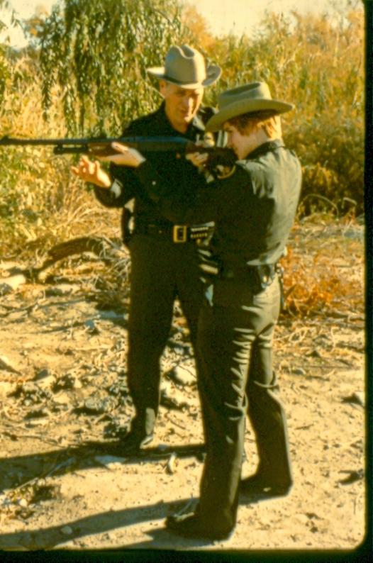 USBP Border Patrol photographs 1970-1990 agents shooting a shotgun