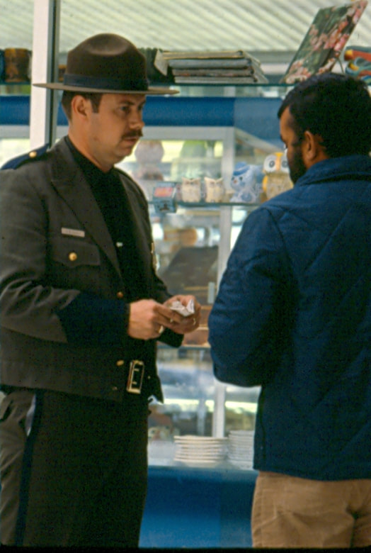 USBP Border Patrol photographs 1970-1990 agent wearing a dress uniform speaking to a man