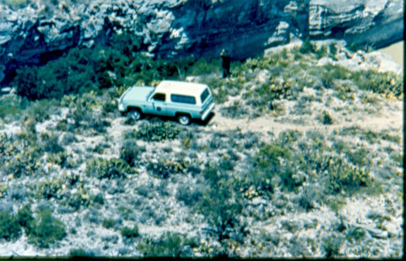 USBP Border Patrol photographs 1970-1990 aerial photo of a sea foam SUV in the field