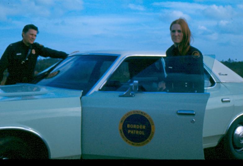 USBP Border Patrol photographs 1970-1990 female agent getting out of a sea foam green car