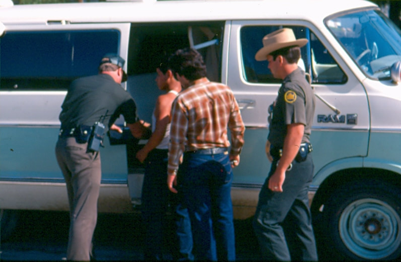 USBP Border Patrol photographs 1970-1990 agents putting aliens in a van