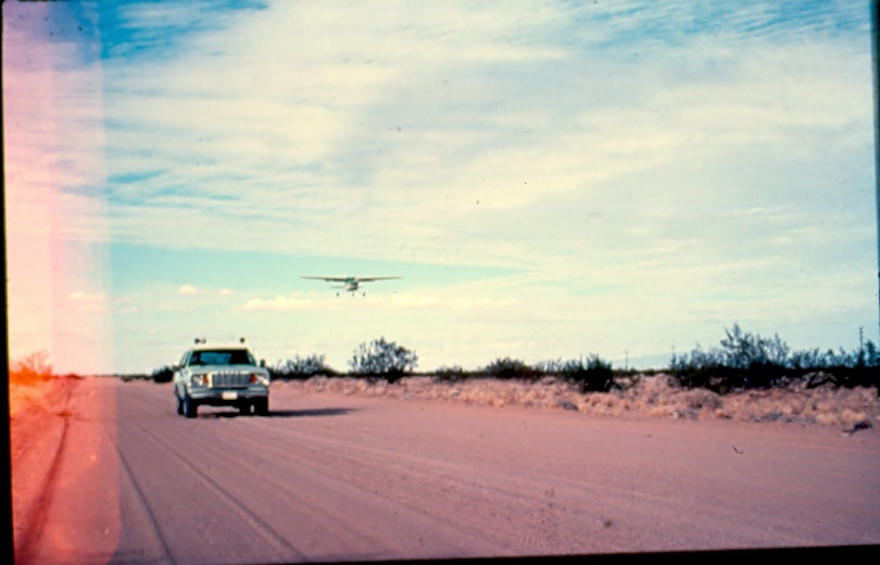 USBP Border Patrol photographs 1970-1990  car racing a airplane