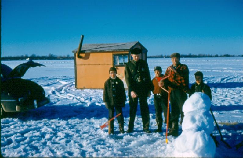 USBP Border Patrol photographs 1970-1990  agent with children and a snow man