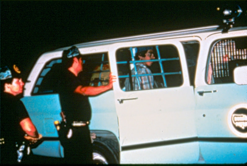 USBP Border Patrol photographs 1970-1990  agents put aliens in a sea foam green SUV