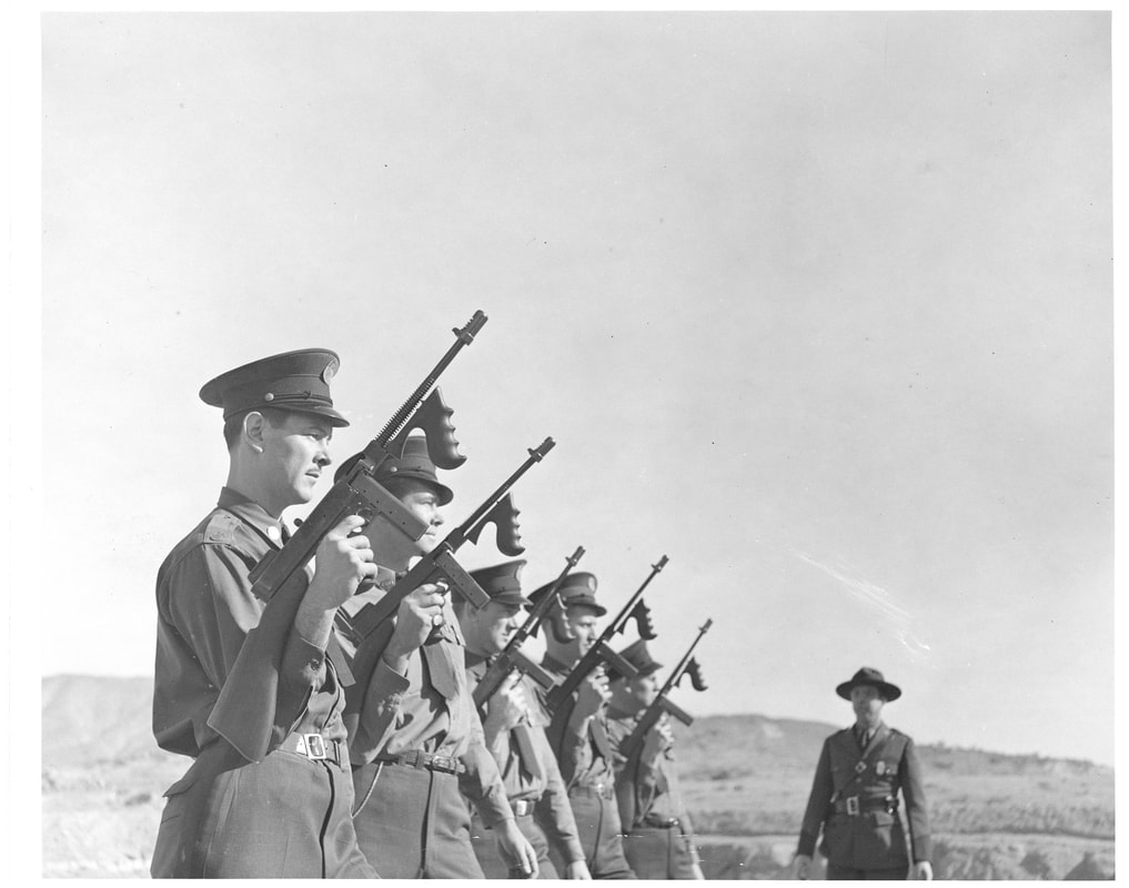 The image captures a historical moment from 1940, showcasing five Border Patrol Inspectors undergoing training on the Thompson submachine gun. This photograph is thought to be closely linked to this memorandum, detailing the procurement of 25 such submachine guns.